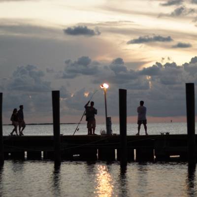 a group of people standing next to a body of water
