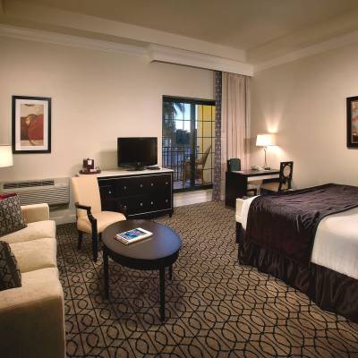 a hotel room with a bed and a flat screen tv