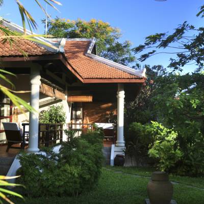 a house with bushes in front of a building