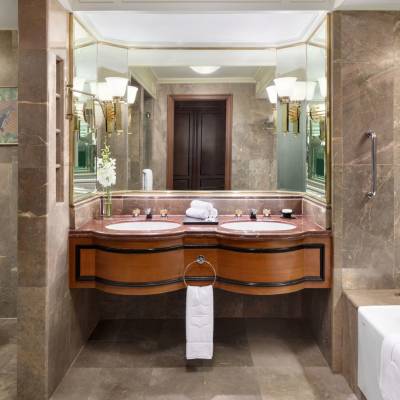 a large white tub sitting next to a sink