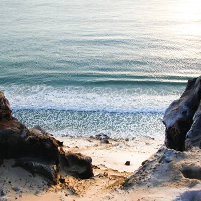 a person lying on a rocky beach