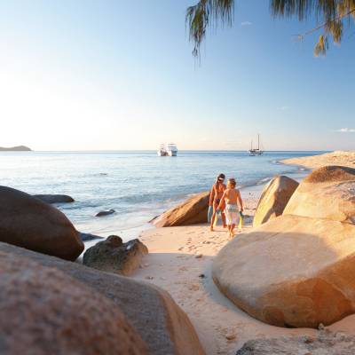 a group of people on a beach near a body of water