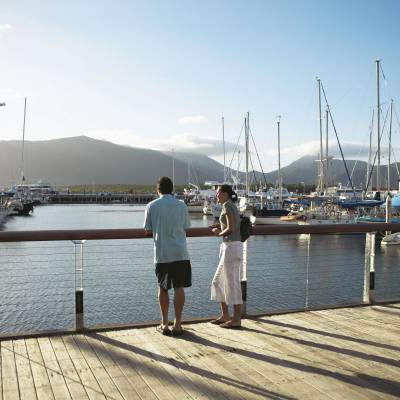 a person sitting on a dock next to a body of water