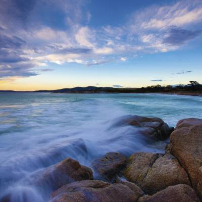 a large waterfall over a body of water