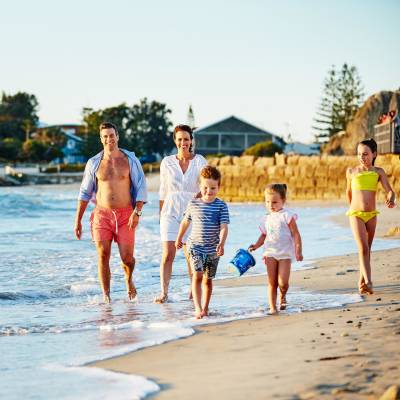 a group of people walking on a beach