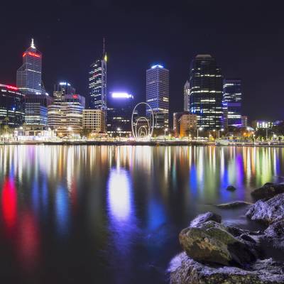 a body of water with a city in the background