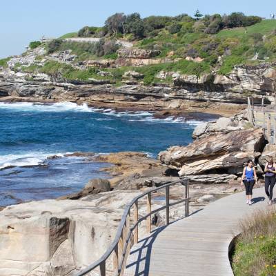 a group of people walking on a rocky beach