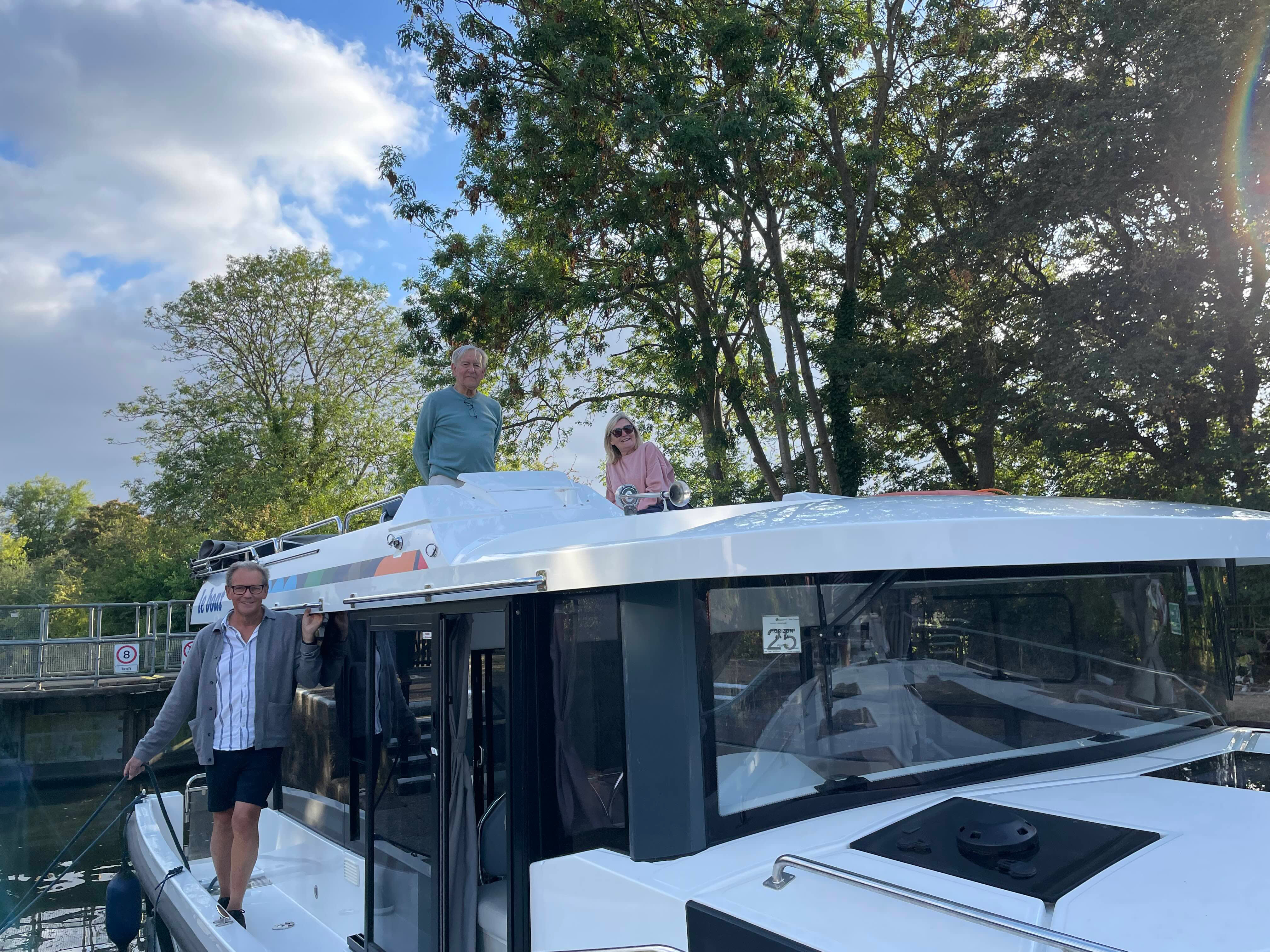 Group on the Horizon boat’s deck working together while navigating through a lock.