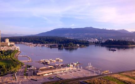 a bridge over a body of water with a city in the background
