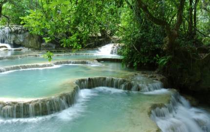 a large waterfall and a pool of water