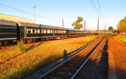 a yellow train is coming down the railroad tracks