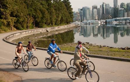a group of people riding on the back of a bicycle
