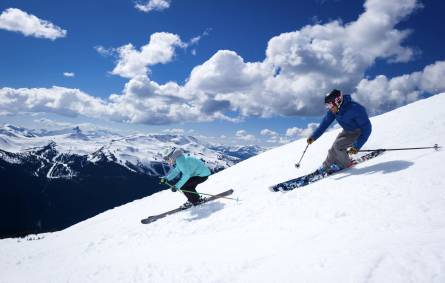 a man riding skis down a snow covered slope