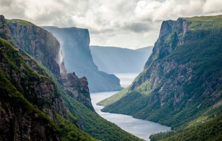 a canyon with Gros Morne National Park in the background