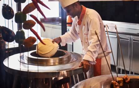 a man cooking in a kitchen preparing food
