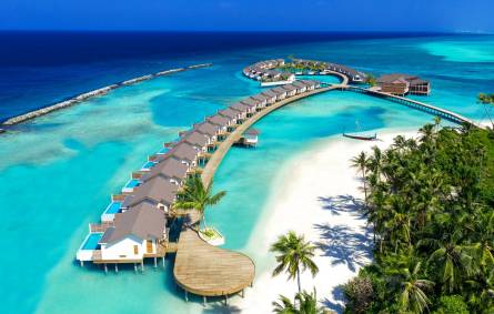 Aerial view of an Maldives island resort surrounded by turquoise blue ocean water