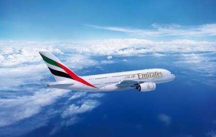 a large passenger jet flying through a cloudy blue sky