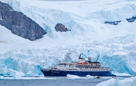 a boat floating on top of a snow covered mountain