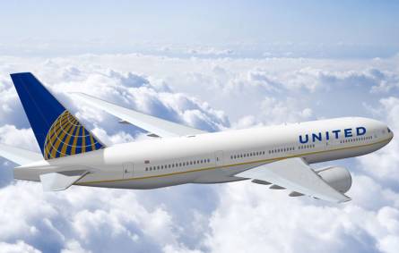 a large passenger jet flying through a cloudy blue sky