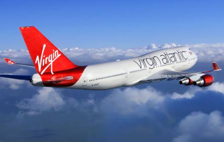 A large Virgin Atlantic Airways passenger jet flying through a cloudy sky