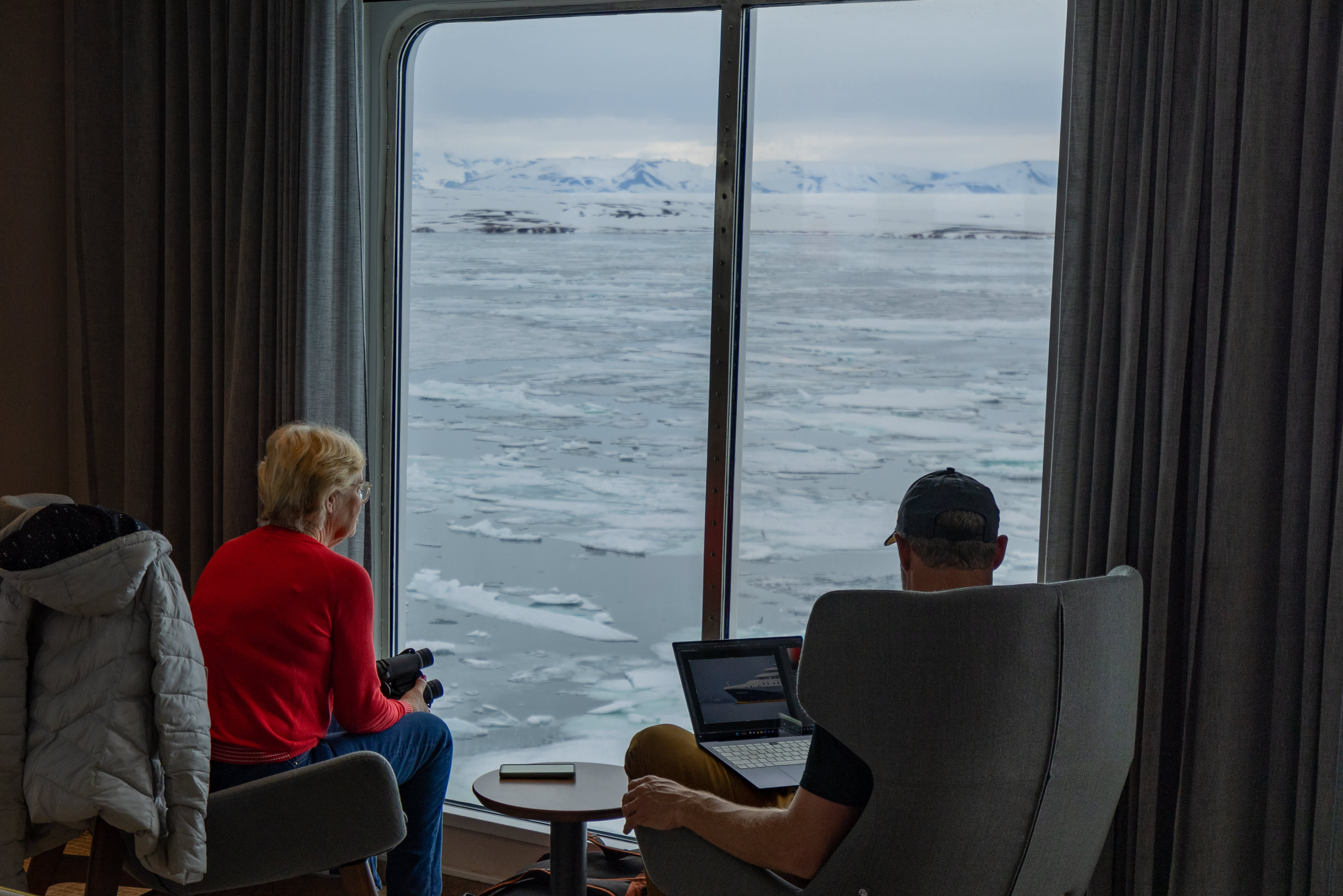 Guest taking in the views of Svalbard from Ultramarine’s Panorama Lounge. Photo by Michelle Sole.