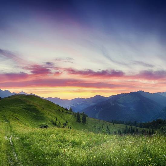 Carpathian mountains summer sunset landscape with dramatic sky and blue mountains