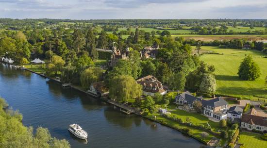 High-angle view of elegant riverside homes along the Thames, desirable property on the banks of the river.