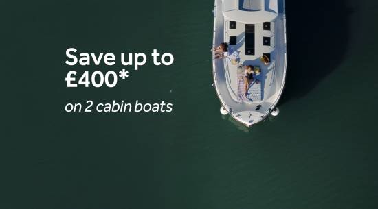 Top-down view of a boat with people sunbathing on deck.