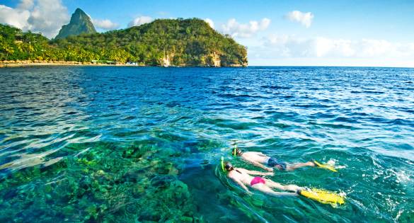 Couple snorkelling in Bluegreen waters of St Lucia
