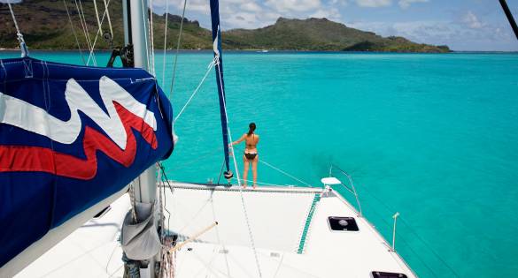 Woman on sailing catamaran trampoline