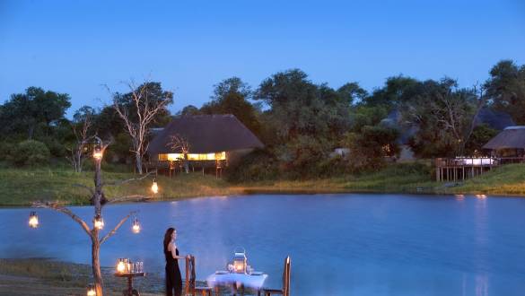 Woman standing at outside dining table of Arathusa Safari Lodge in Kruger, South Africa