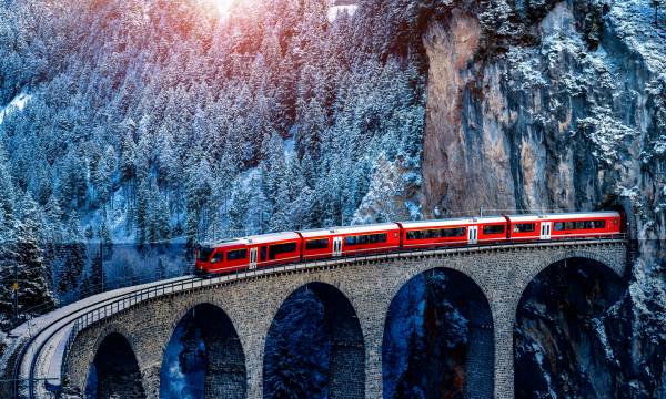 Aerial view of Train passing through famous mountain in Filisur, Switzerland. train express in Swiss Alps snow winter scenery.