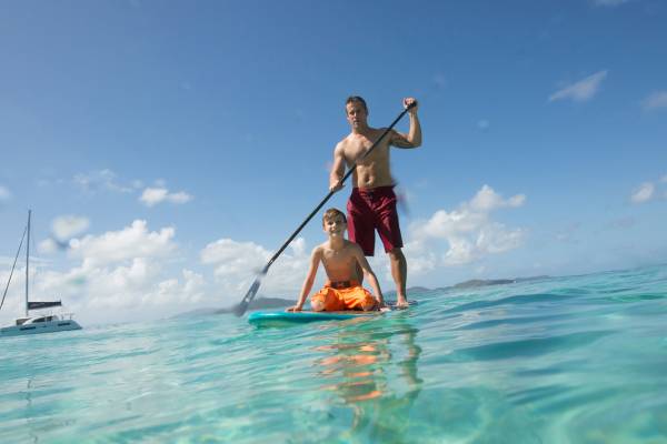 father and son paddleboarding in the bvi