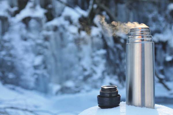 Thermos flask in the snow