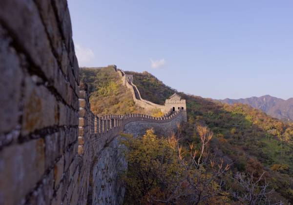 a view of a stone building with a mountain in the background