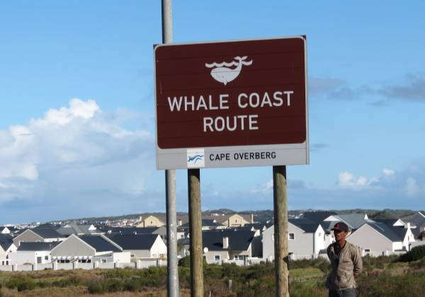 a group of people standing in front of a sign