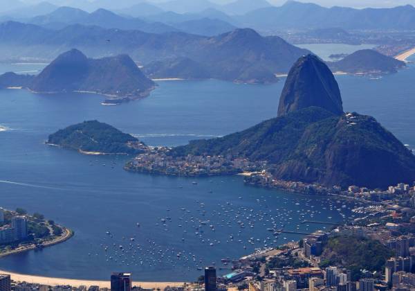 a large body of water with a mountain in the background