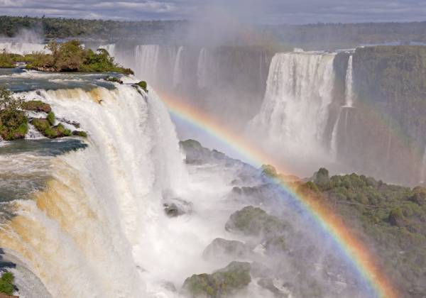 a large waterfall coming out of the water with Iguazu Falls in the background