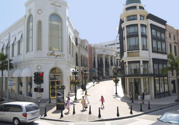 a group of people walking down a street in front of a building