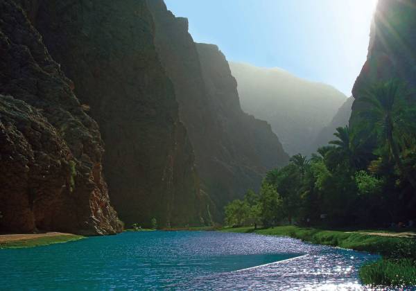 a large body of water with a mountain in the background