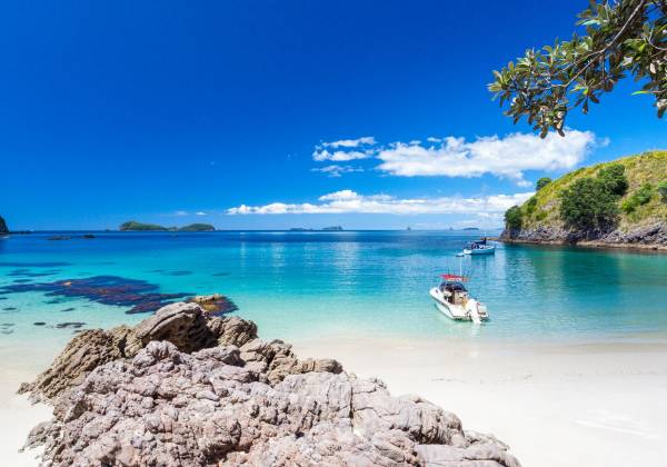 a rocky beach next to a body of water