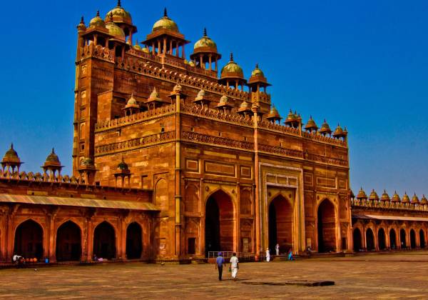 a large stone building with Fatehpur Sikri in the background