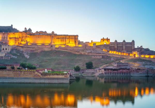 a train crossing a bridge over a body of water