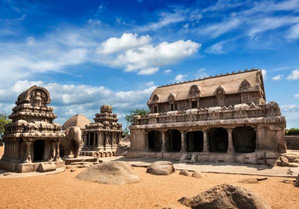 a stone building that has a large rock