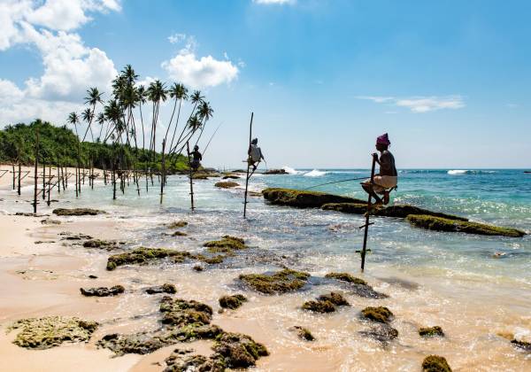 a group of people on a beach near a body of water