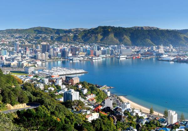 a large body of water with a city in the background