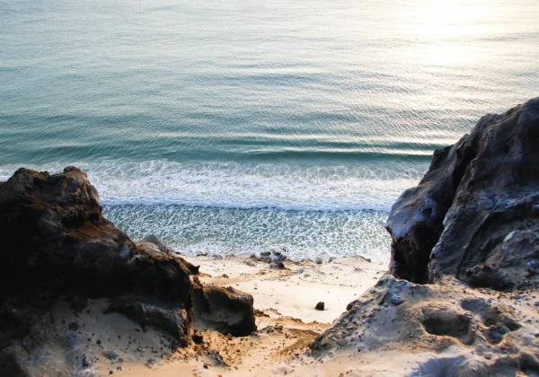 a person lying on a rocky beach