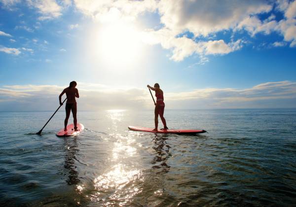 a group of people riding skis on a body of water