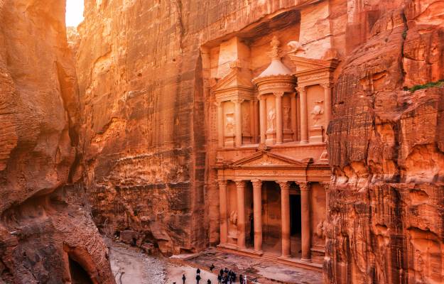 stone temple in Petra, sunset people at base