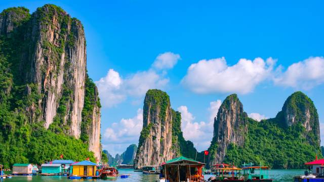 Floating fishing village and rock island in Halong Bay, Vietnam, Southeast Asia. UNESCO World Heritage Site. Junk boat cruise to Ha Long Bay. Landscape. Popular landmark, famous destination of Vietnam